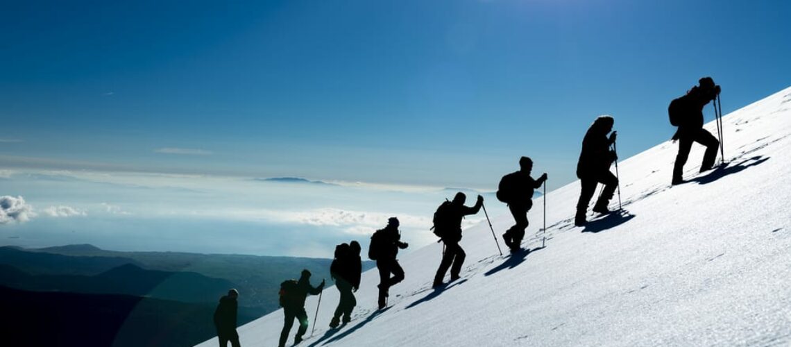 mountain climbers standing in one line conquering nature ice snow challenge climbing up