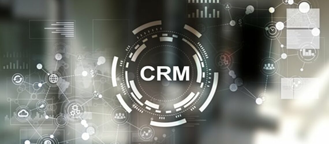 Image shows a faded background of charts and workflows and says CRM in the center